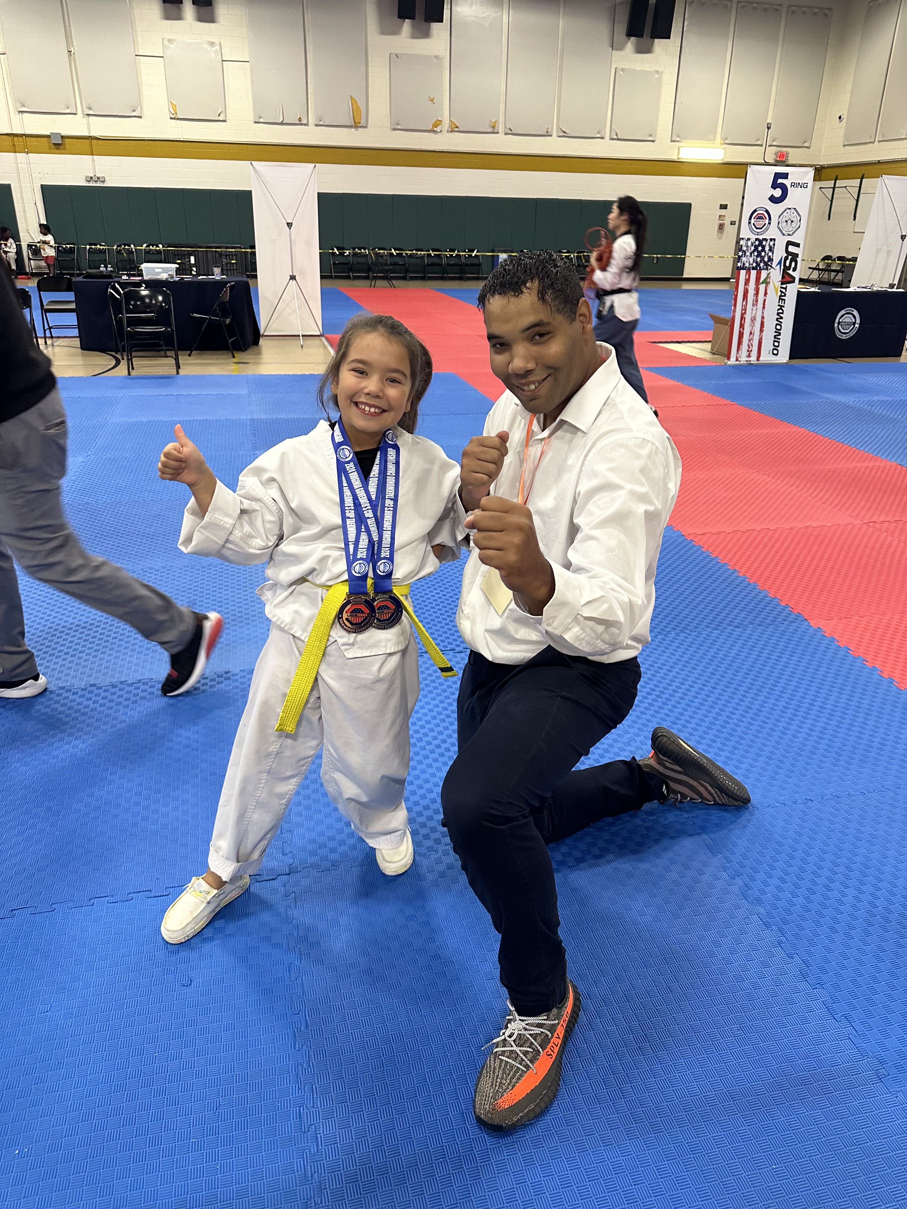 Instructor celebrating with a medal-winning student